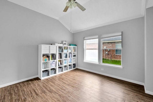 rec room featuring a ceiling fan, crown molding, wood finished floors, baseboards, and lofted ceiling