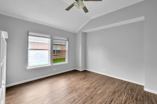 spare room featuring a ceiling fan, wood finished floors, baseboards, lofted ceiling, and ornamental molding