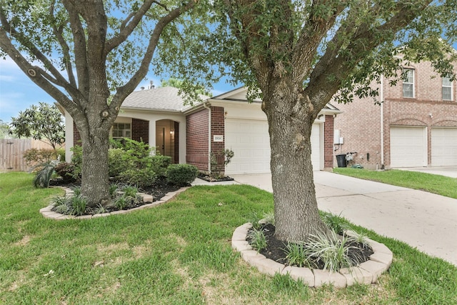 view of front of home featuring a front lawn, fence, brick siding, an attached garage, and driveway