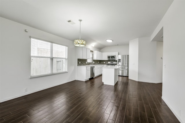 kitchen with dark wood-type flooring, light countertops, appliances with stainless steel finishes, and visible vents