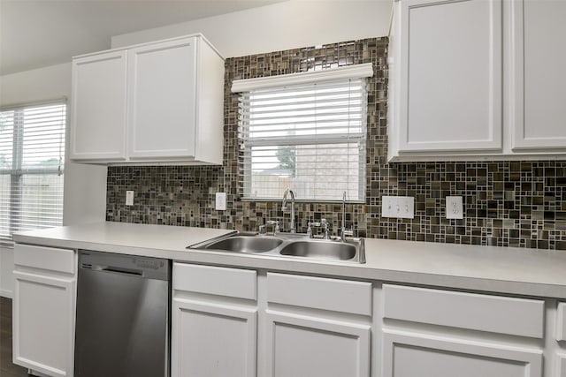kitchen featuring stainless steel dishwasher, a sink, white cabinetry, and light countertops