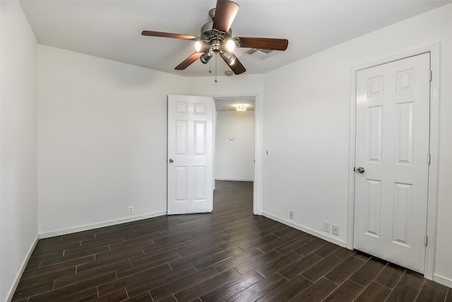 unfurnished bedroom featuring baseboards, visible vents, ceiling fan, and dark wood-type flooring