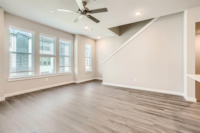 unfurnished living room featuring baseboards, a ceiling fan, recessed lighting, and wood finished floors