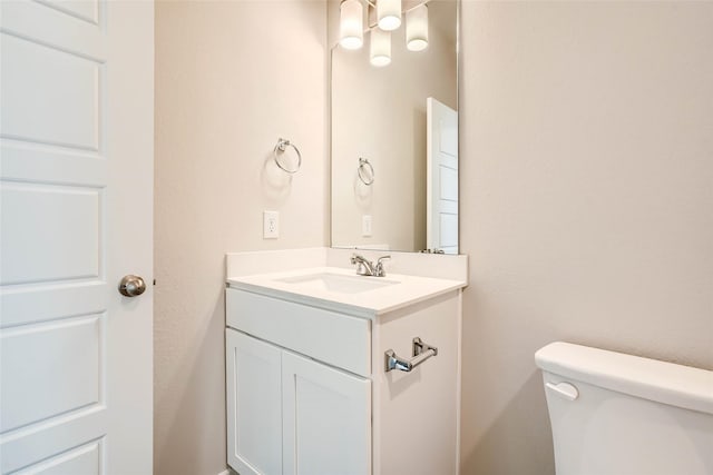 half bath with vanity and toilet