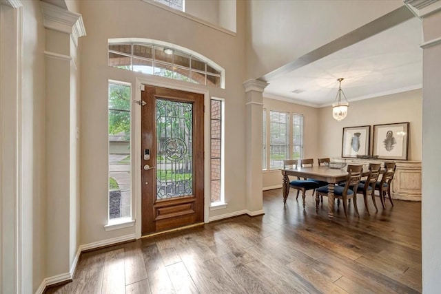 13538 Scenic Glade Dr, Houston, TX 77059 - entrance foyer with wood finished floors, ornamental molding, a chandelier, decorative columns, and baseboards