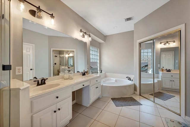 13538 Scenic Glade Dr, Houston, TX 77059 - bathroom featuring a bath, double vanity, and tile patterned floors