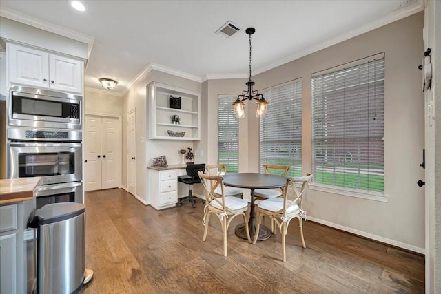 13538 Scenic Glade Dr, Houston, TX 77059 - dining area with baseboards, wood finished floors, ornamental molding, and a chandelier