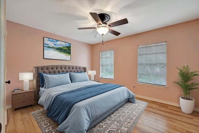 13538 Scenic Glade Dr, Houston, TX 77059 - bedroom featuring baseboards, light wood-style flooring, and a ceiling fan