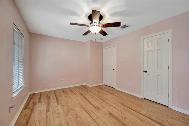 13538 Scenic Glade Dr, Houston, TX 77059 - unfurnished bedroom featuring light wood-style flooring, baseboards, and a ceiling fan