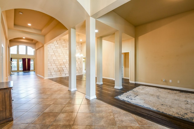 629 Pelican Harbour Dr, Texas City, TX 77590 - unfurnished living room with arched walkways, baseboards, recessed lighting, and a chandelier