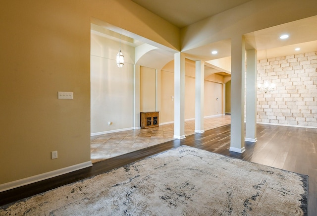 629 Pelican Harbour Dr, Texas City, TX 77590 - unfurnished living room featuring arched walkways, wood finished floors, baseboards, and recessed lighting