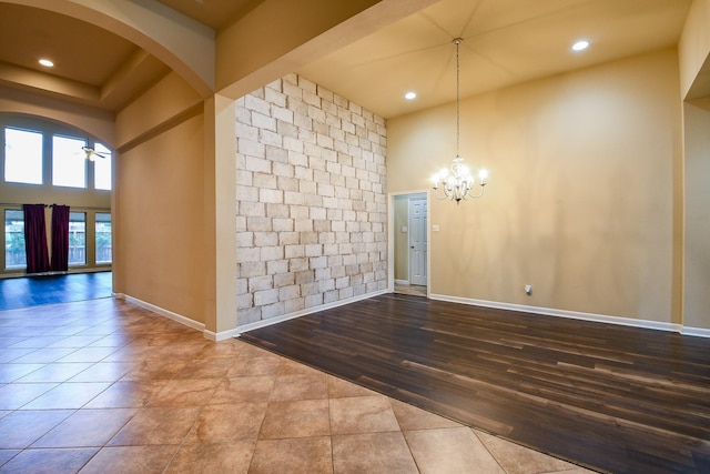 629 Pelican Harbour Dr, Texas City, TX 77590 - empty room featuring a chandelier, arched walkways, recessed lighting, wood finished floors, and baseboards