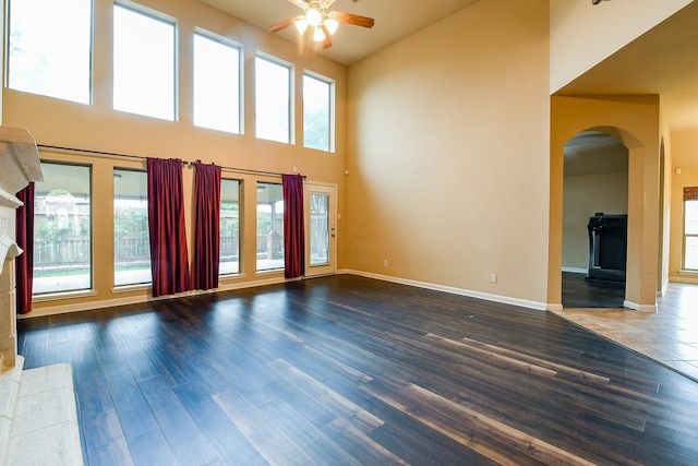 629 Pelican Harbour Dr, Texas City, TX 77590 - unfurnished living room featuring ceiling fan, arched walkways, plenty of natural light, high vaulted ceiling, and wood finished floors