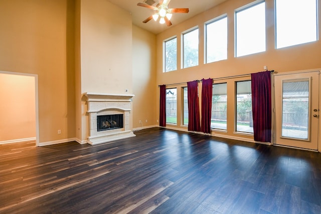629 Pelican Harbour Dr, Texas City, TX 77590 - unfurnished living room featuring high vaulted ceiling, ceiling fan, plenty of natural light, dark wood-style floors, and a tile fireplace