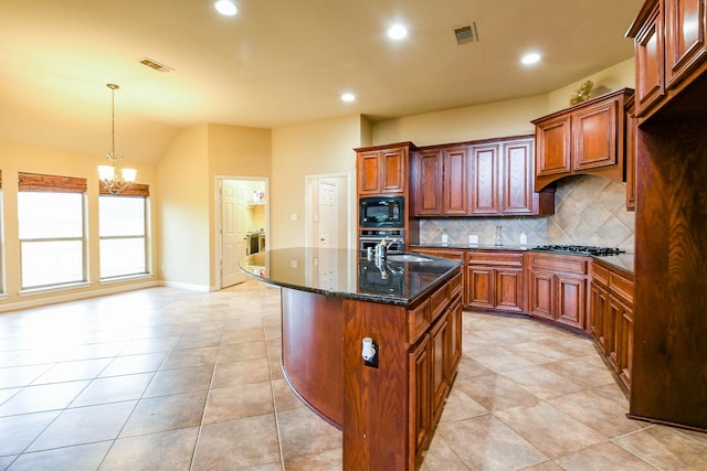 629 Pelican Harbour Dr, Texas City, TX 77590 - kitchen with appliances with stainless steel finishes, backsplash, a chandelier, dark stone countertops, and an island with sink
