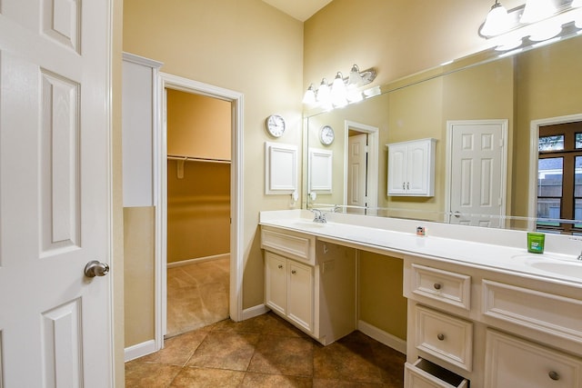 629 Pelican Harbour Dr, Texas City, TX 77590 - full bathroom with double vanity, a walk in closet, tile patterned flooring, and baseboards