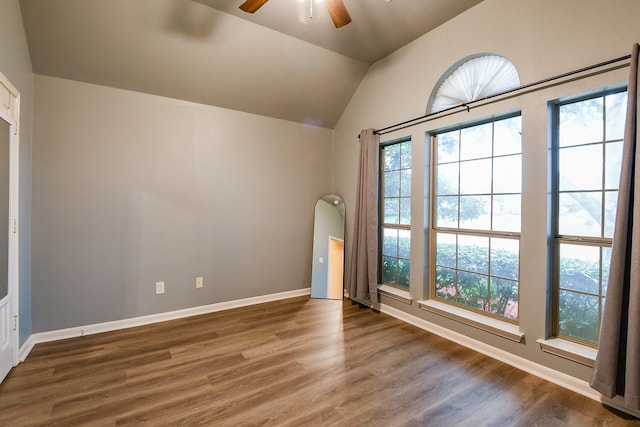 629 Pelican Harbour Dr, Texas City, TX 77590 - empty room with ceiling fan, healthy amount of natural light, wood finished floors, vaulted ceiling, and baseboards
