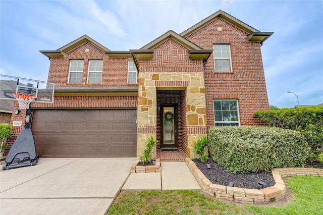 traditional-style home with an attached garage, concrete driveway, stone siding, and brick siding
