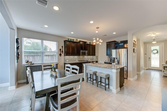 dining space featuring visible vents, light tile patterned floors, baseboards, an inviting chandelier, and recessed lighting