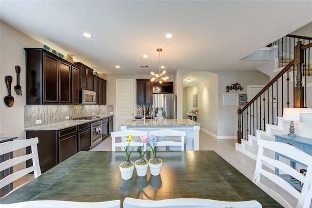 dining area with baseboards, stairway, recessed lighting, a chandelier, and light tile patterned floors