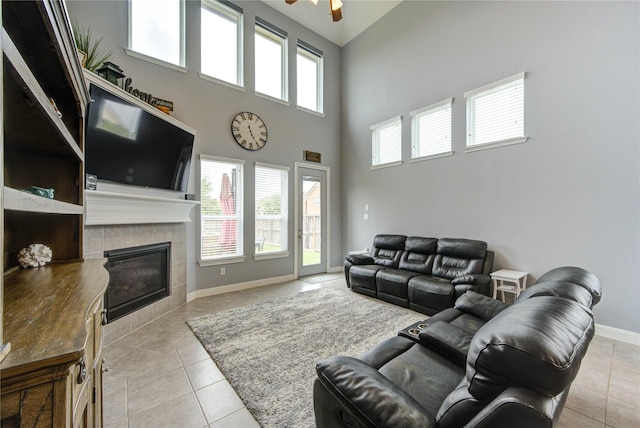 living room featuring a high ceiling, plenty of natural light, and light tile patterned floors