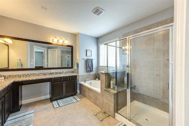 bathroom featuring tile patterned floors, a shower stall, a bath, and vanity