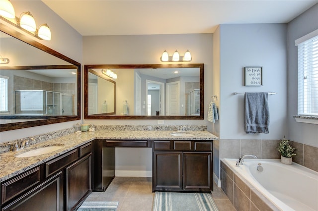bathroom with double vanity, a sink, a bath, and a shower stall