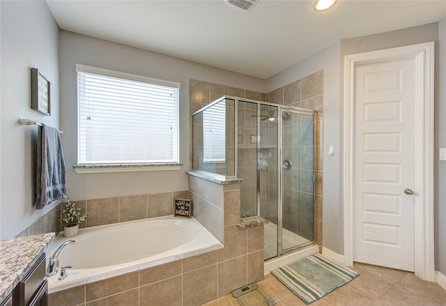 full bathroom with tile patterned flooring, vanity, visible vents, a bath, and a shower stall