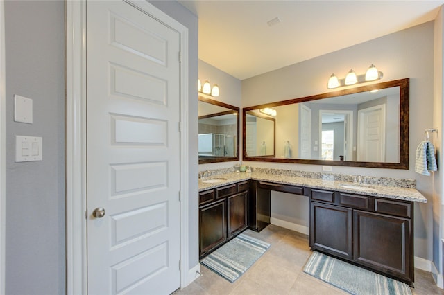 full bath featuring a sink, tile patterned flooring, and double vanity
