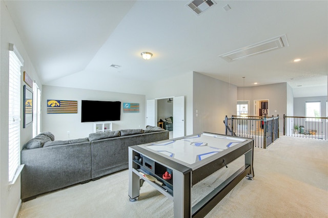 playroom with vaulted ceiling, attic access, light colored carpet, and visible vents