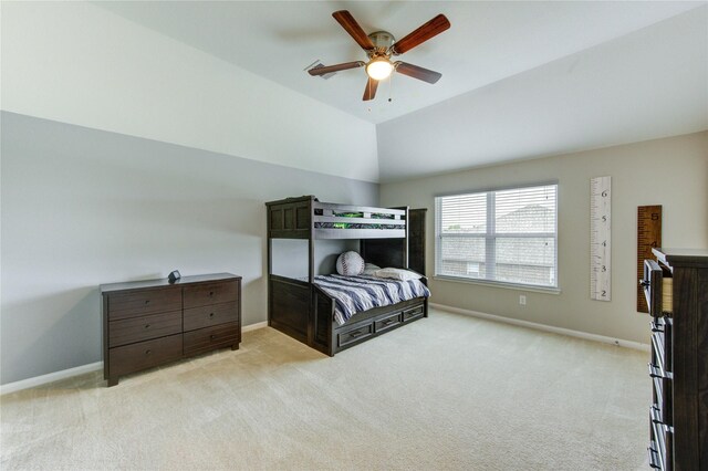bedroom with baseboards, light carpet, a ceiling fan, and lofted ceiling