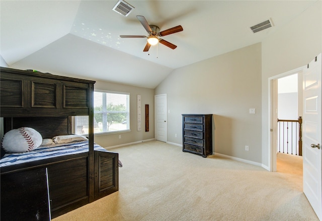 bedroom featuring baseboards, visible vents, light carpet, and lofted ceiling