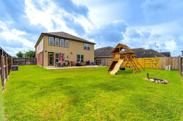 back of property featuring a yard and a fenced backyard