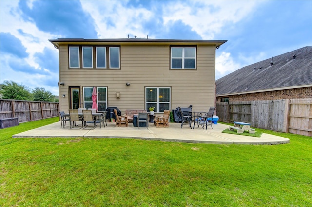 rear view of property featuring a lawn, a patio, and a fenced backyard