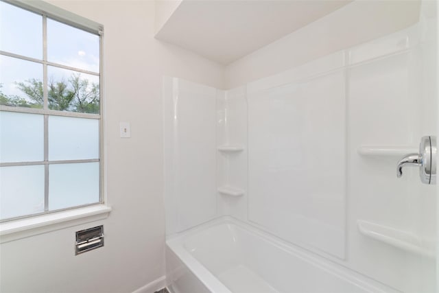 bathroom featuring baseboards and walk in shower