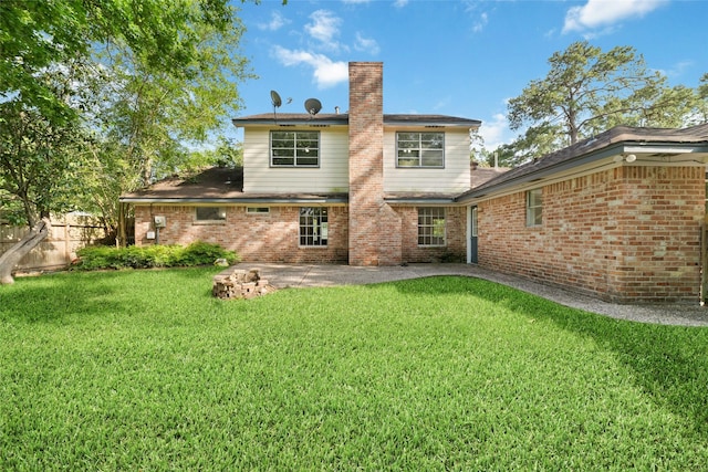 rear view of house featuring a lawn, a patio, fence, and a chimney