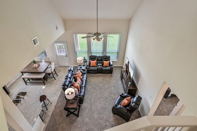 living area with visible vents, carpet, ceiling fan, and baseboards