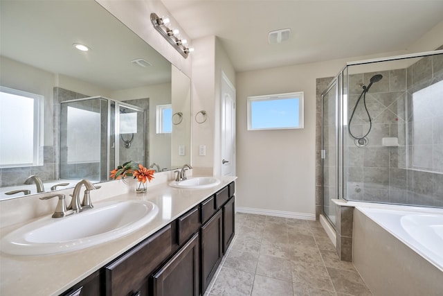 23109 Zinfandel Dr, Alvin, TX 77511 - bathroom featuring a shower stall, double vanity, a garden tub, and baseboards