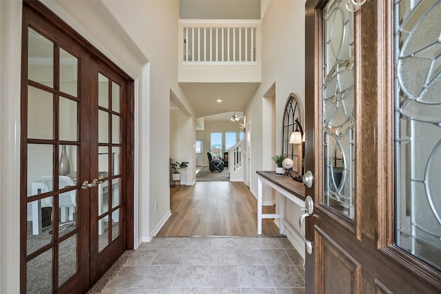 entryway with baseboards and french doors