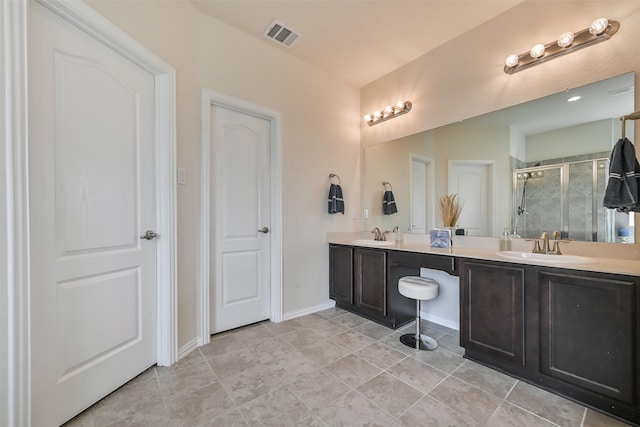 bathroom with double vanity, visible vents, a shower stall, and a sink