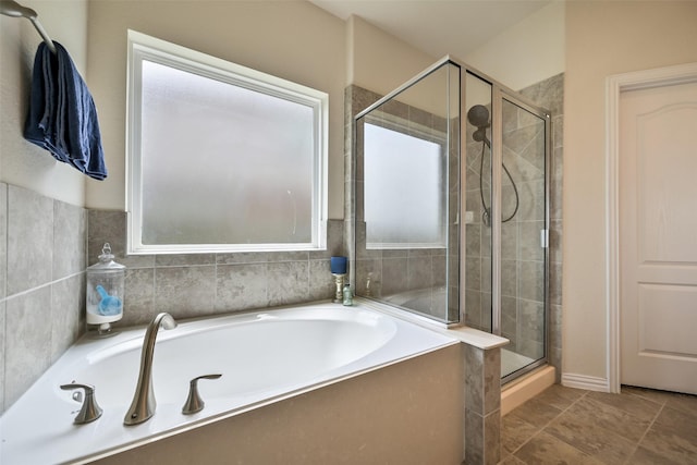 full bath featuring a bath and a stall shower
