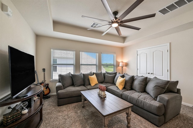 23109 Zinfandel Dr, Alvin, TX 77511 - carpeted living room with a tray ceiling, ceiling fan, and baseboards