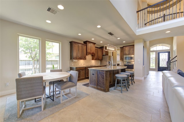 kitchen with visible vents, recessed lighting, appliances with stainless steel finishes, and a breakfast bar area