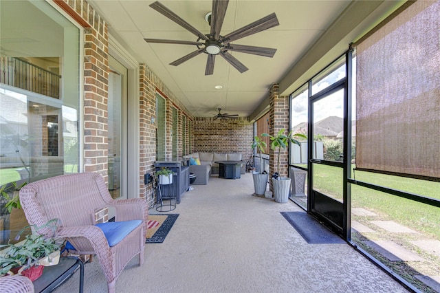 sunroom featuring a ceiling fan and an outdoor hangout area
