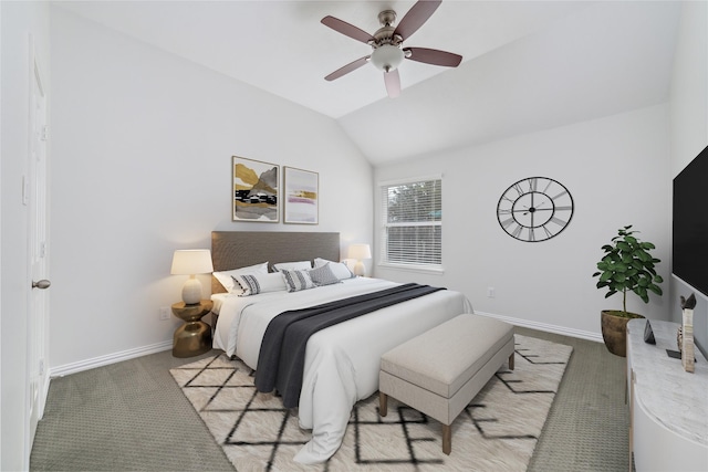 carpeted bedroom with baseboards, a ceiling fan, and vaulted ceiling