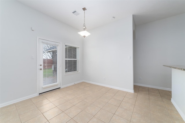 unfurnished dining area with baseboards, light tile patterned flooring, and visible vents