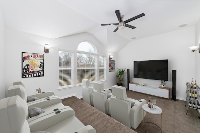 carpeted home theater featuring ceiling fan, vaulted ceiling, and baseboards