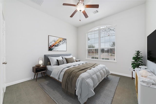 bedroom featuring baseboards, a ceiling fan, dark colored carpet, and visible vents