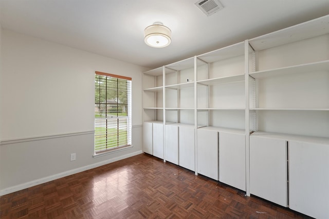 unfurnished room with baseboards and visible vents