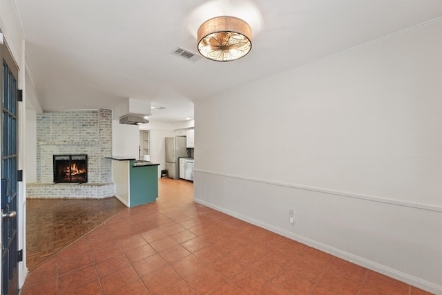 unfurnished living room featuring visible vents and a fireplace
